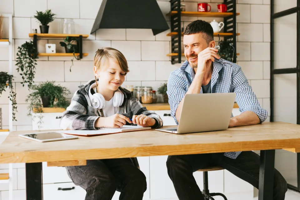 Parent and child working together at a kitchen counter